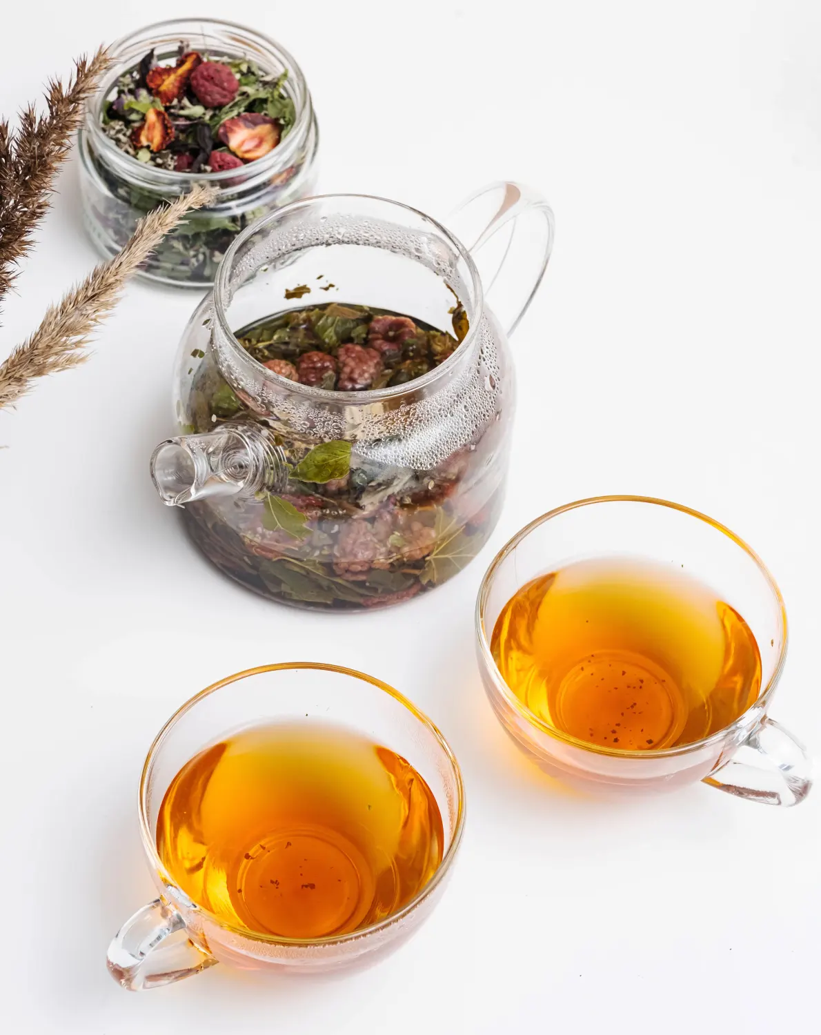 glass-teapot-cup-of-herbal-tea-with-berries.webp